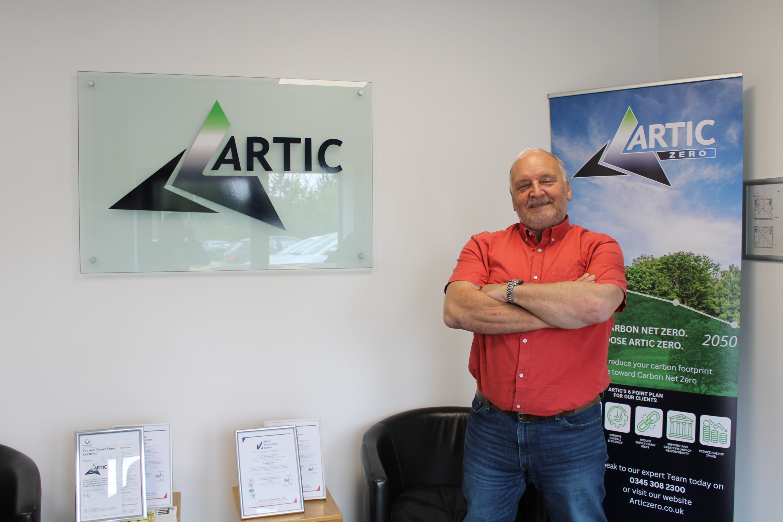 Vince Mayne Standing infront of the Artic sign