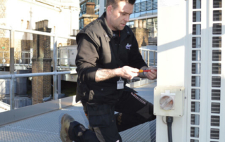 Artic Engineer servicing a condenser on the roof