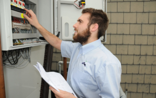 Artic Engineer working on a control panel